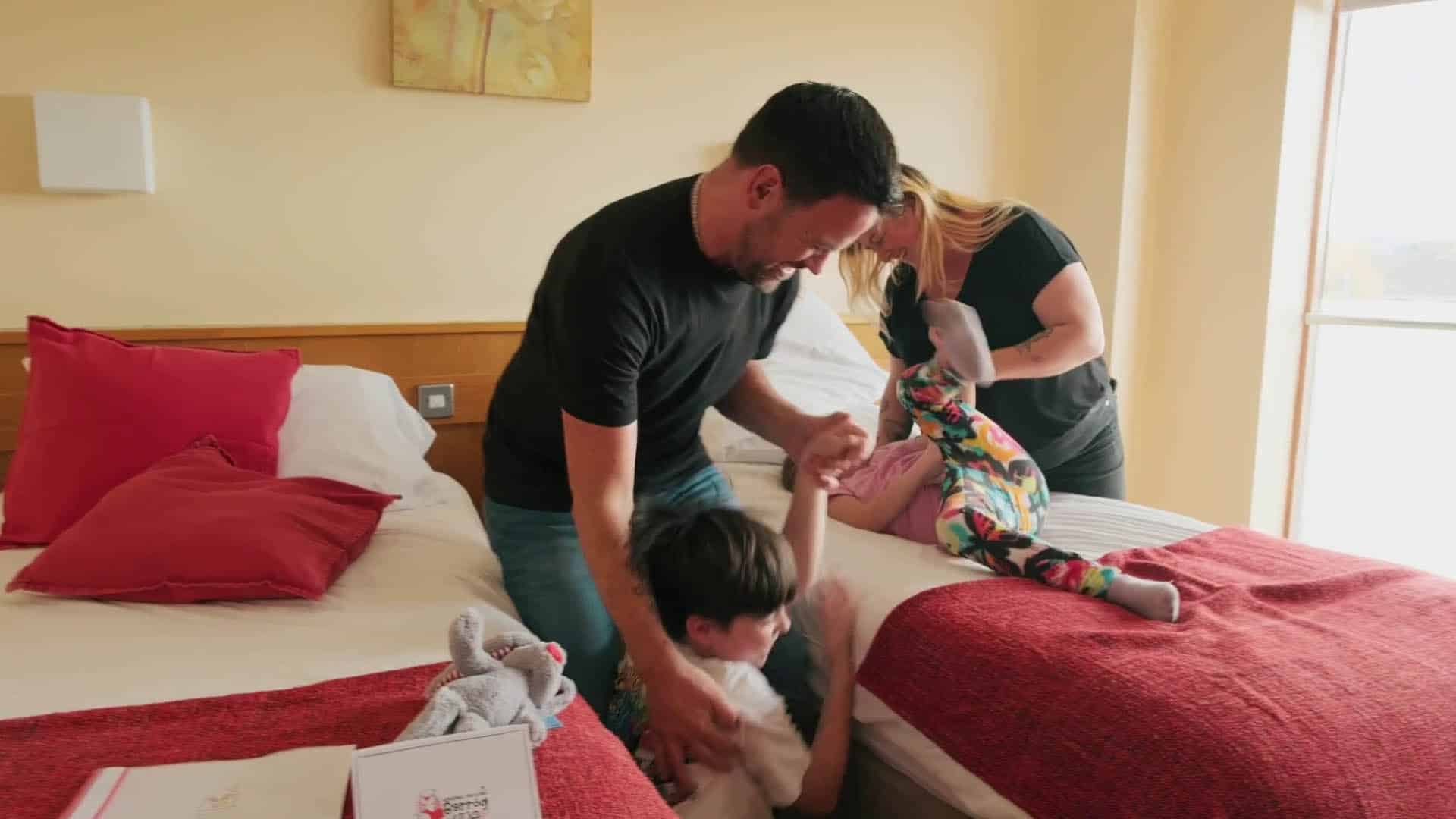 Family playing in bedroom