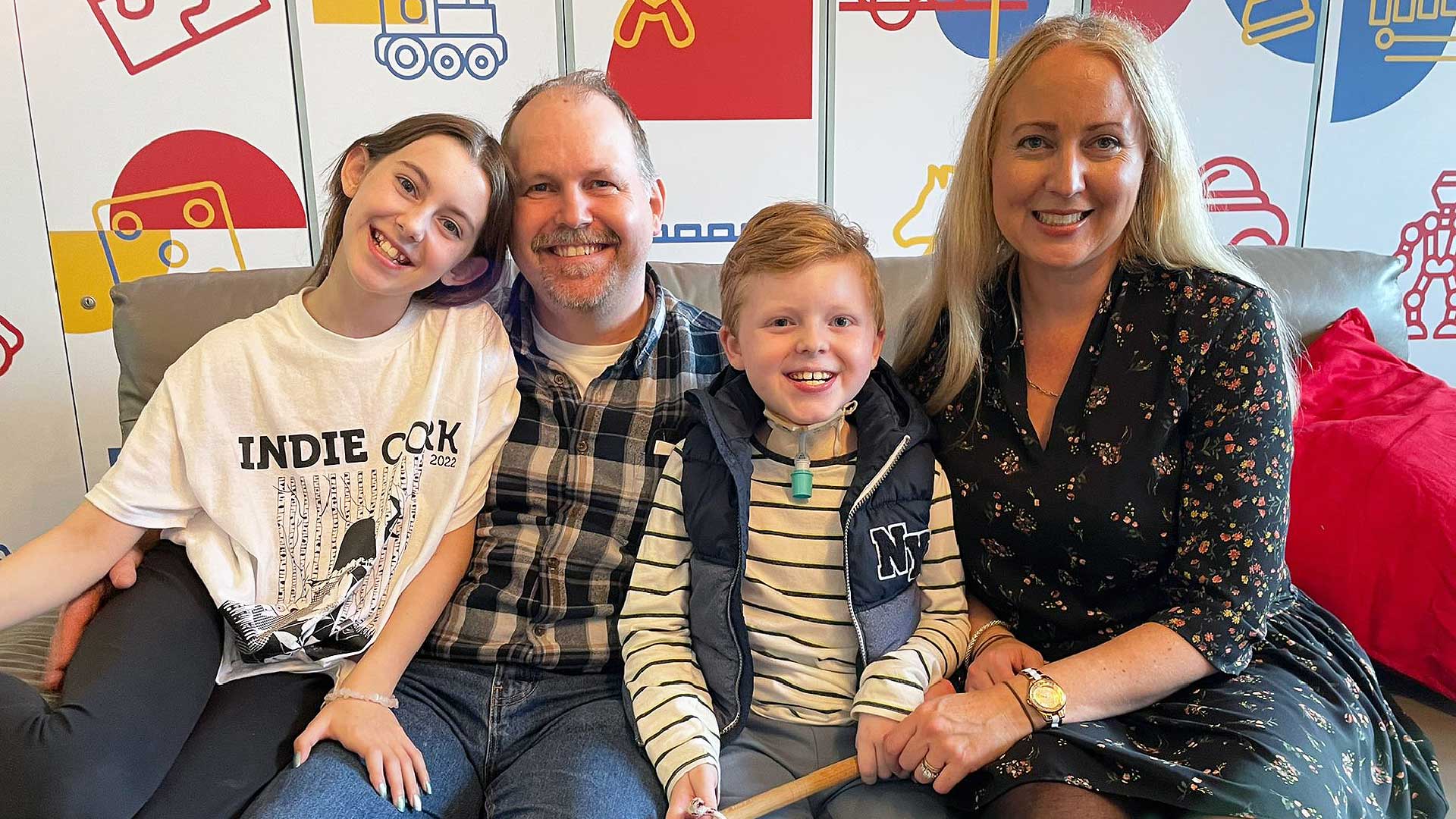 Family smiling on couch