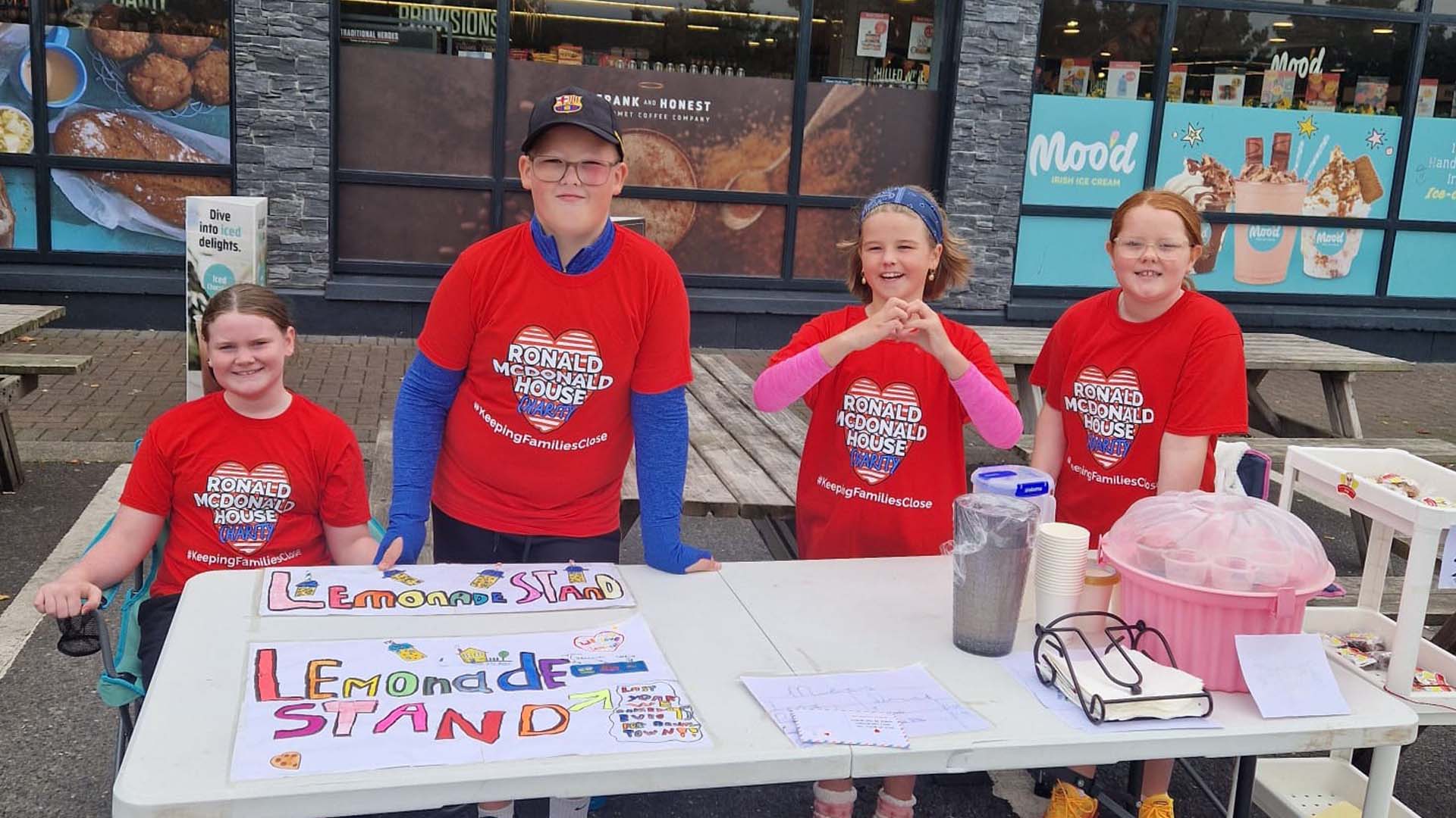 Group of kids selling lemonade in charity T-shirts