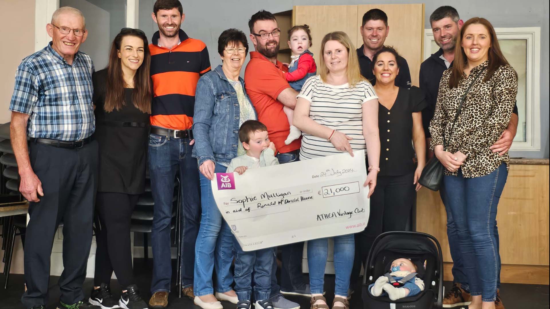 Group of people holding a cheque