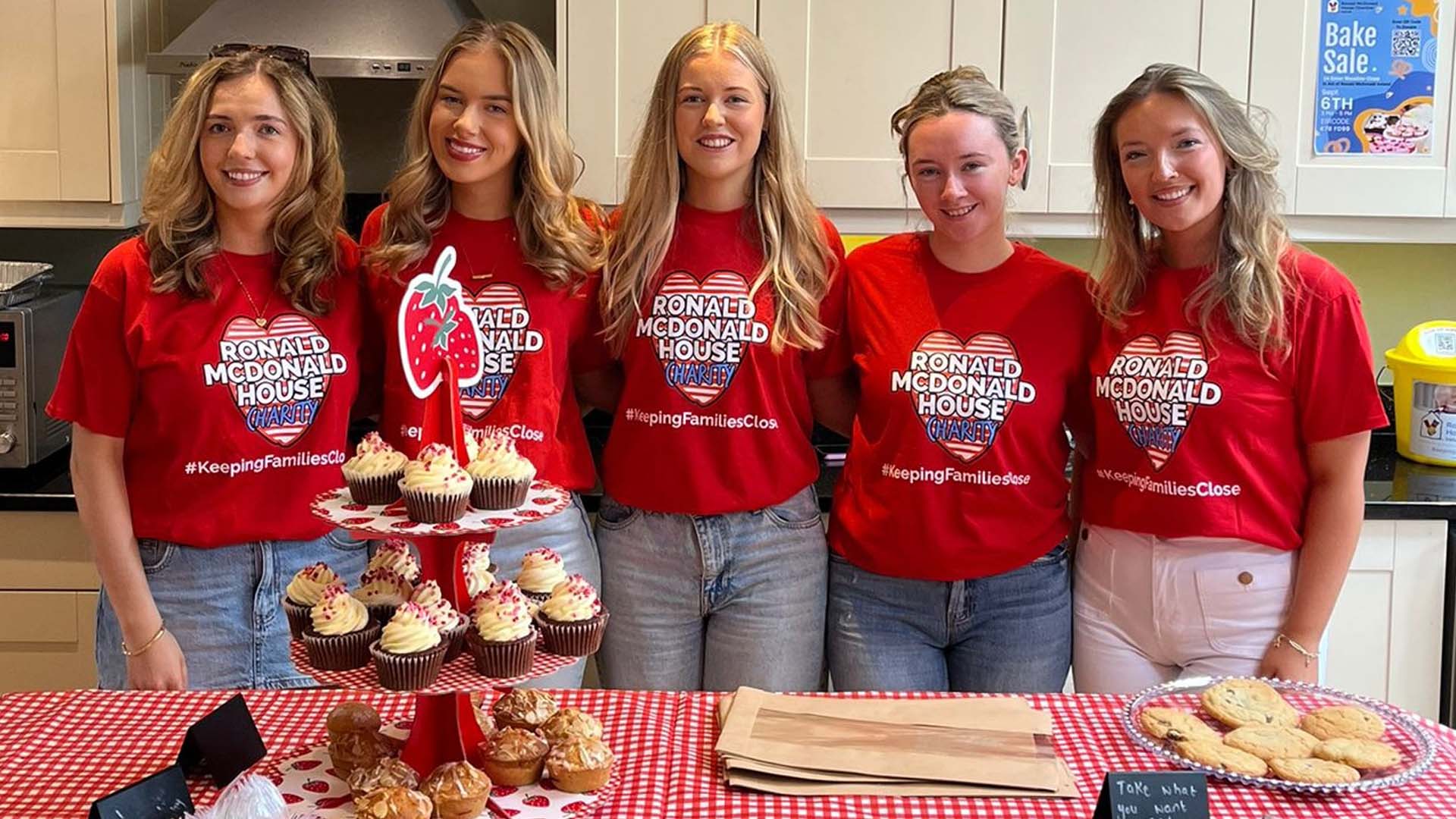 Group of women in charity tops at bakesale