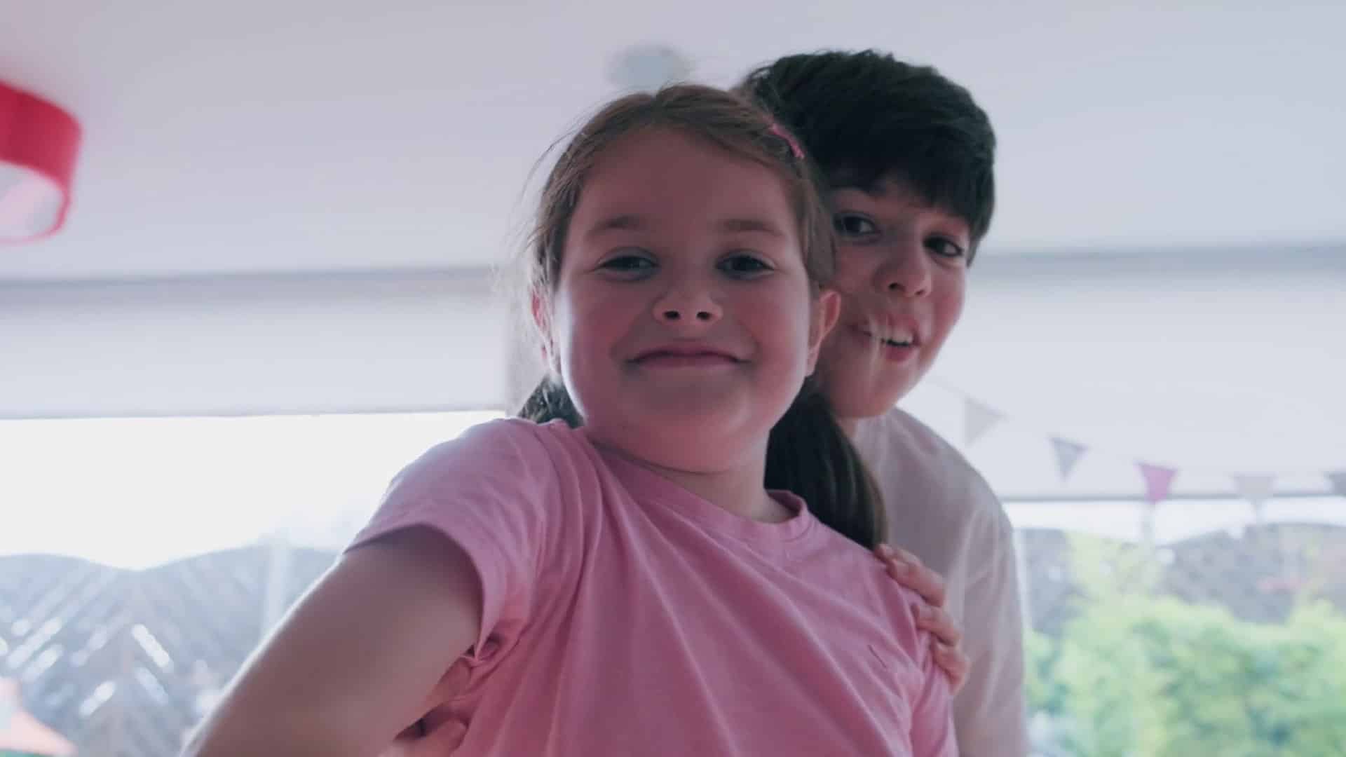 Siblings smiling at camera